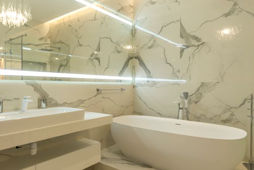 Modern bathroom with marble finishes and a sculptural bathtub